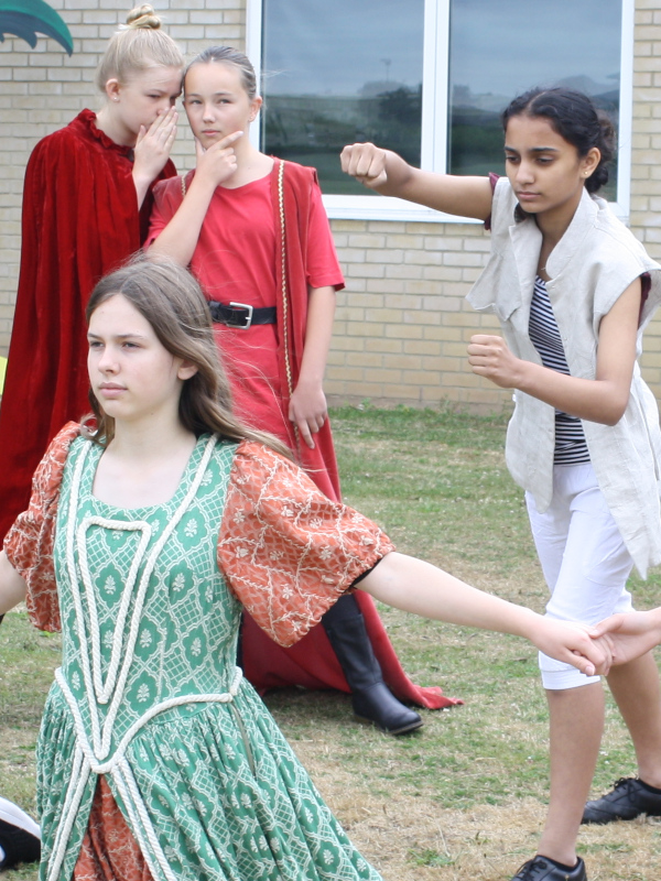 Students take part in an outdoor dramatic performance.